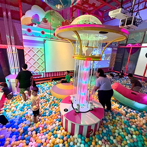 Kids playing around the glowing candy carousel at Candeeland El Centro