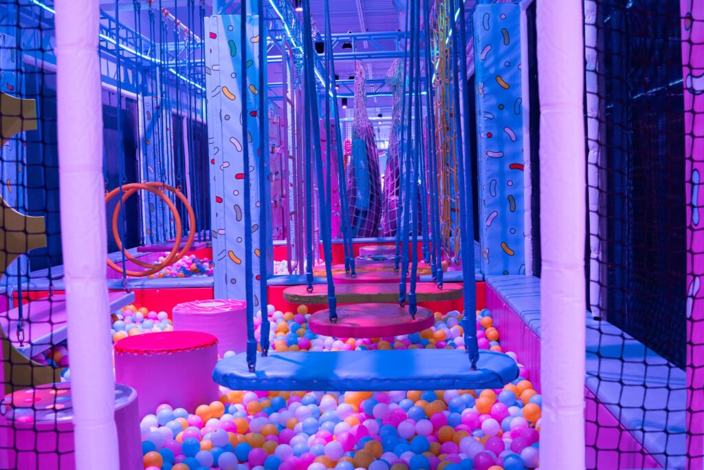 Ball pit and hanging swing platforms inside the play structure at Candeeland El Centro